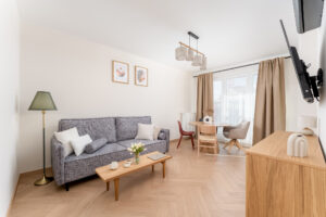 salon, kanapa rozkładana, duży stół, telewizor, wyjście na balkon, 4 piętro jasne mieszkanie Wieliczka